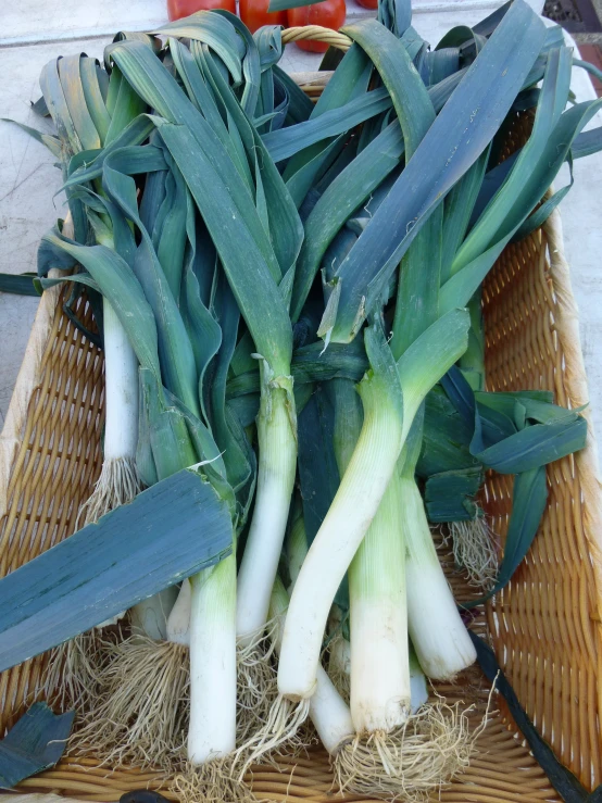 several large green vegetables in an outdoor basket