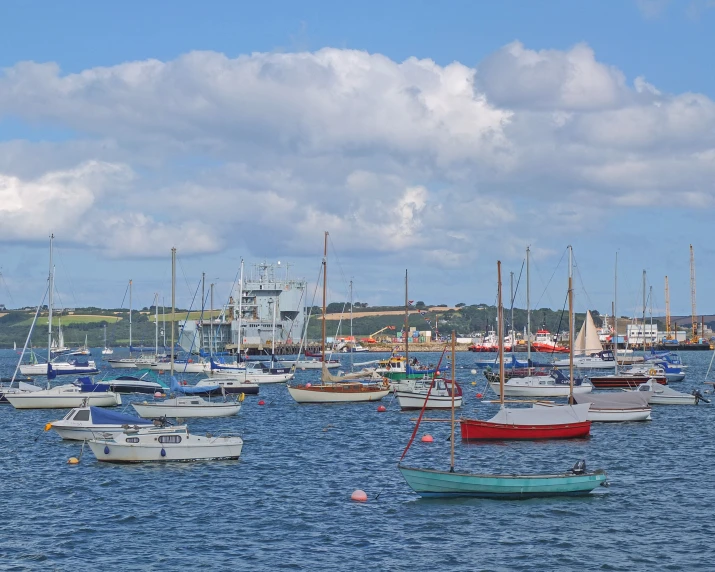 a group of boats floating on top of a blue ocean