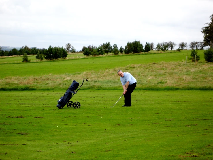 a man playing golf on a grassy course