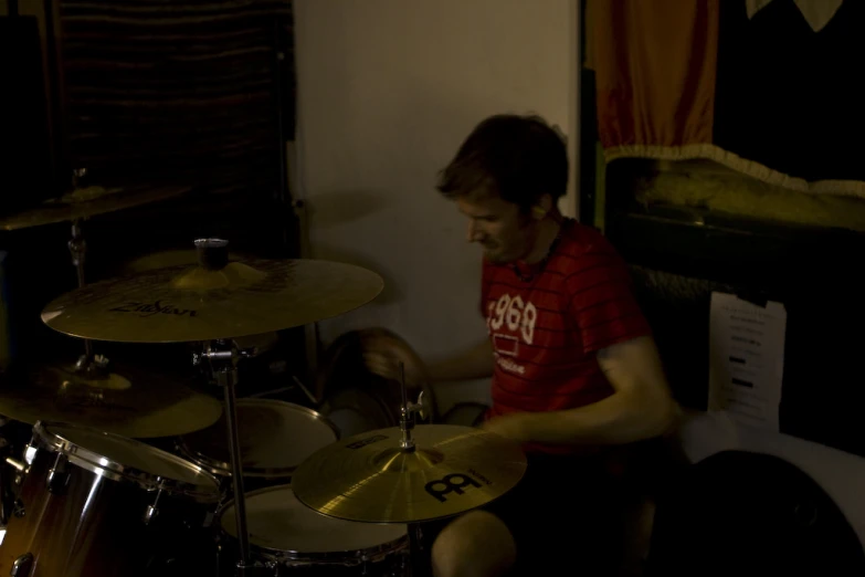 a man is sitting in front of a drumset