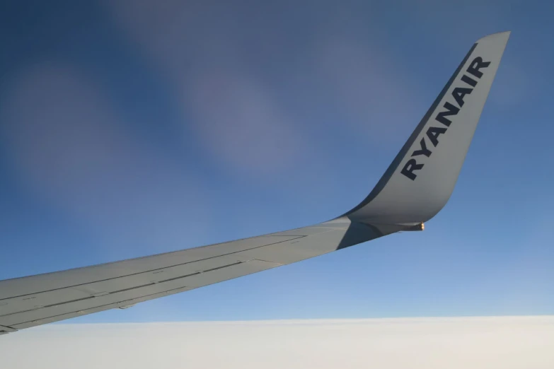 the wing of an airplane with the letters ryanair painted on it