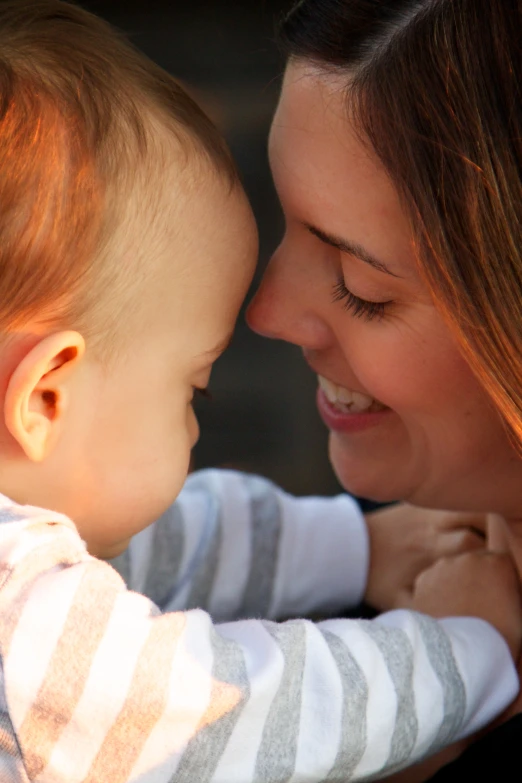 a mom and her toddler boy in the light