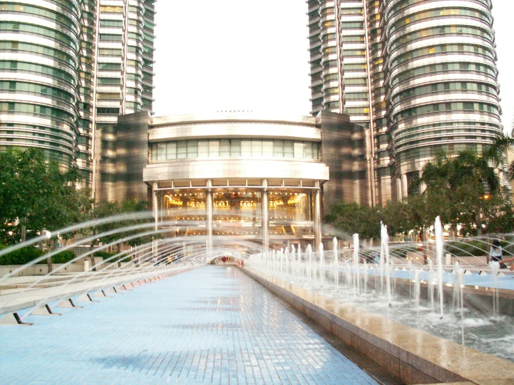an architectural and artistic image of buildings behind a fountain