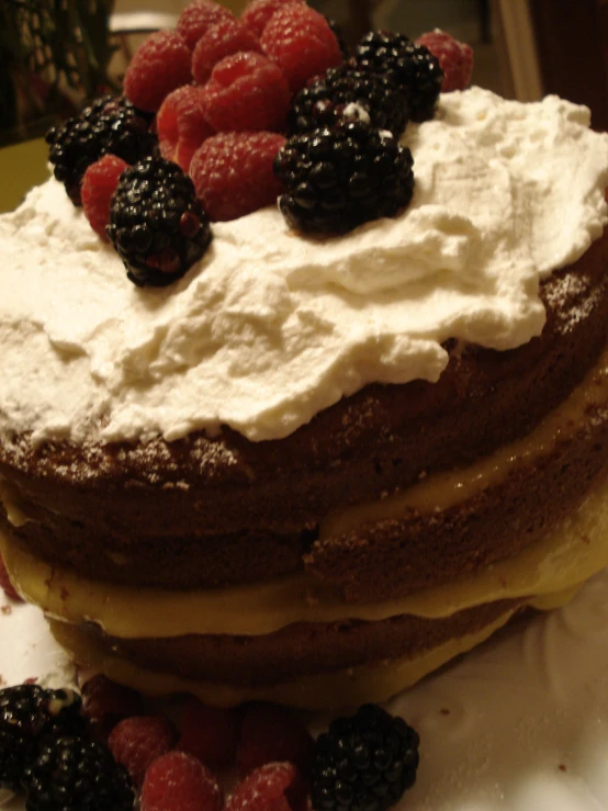 a white plate topped with a layered dessert with fruit