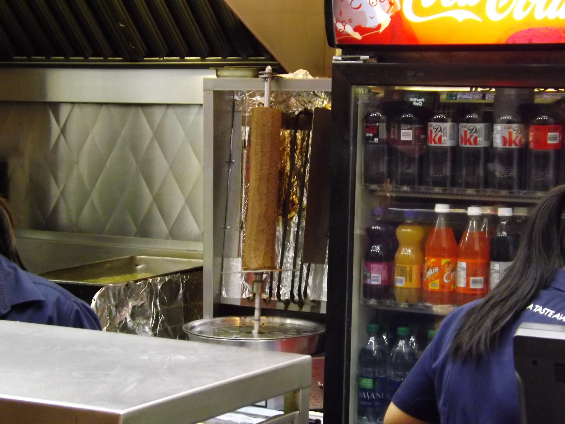 a woman at the counter in front of an ice cream shop