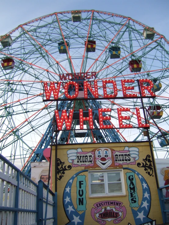 a large ferris wheel sitting above an entrance