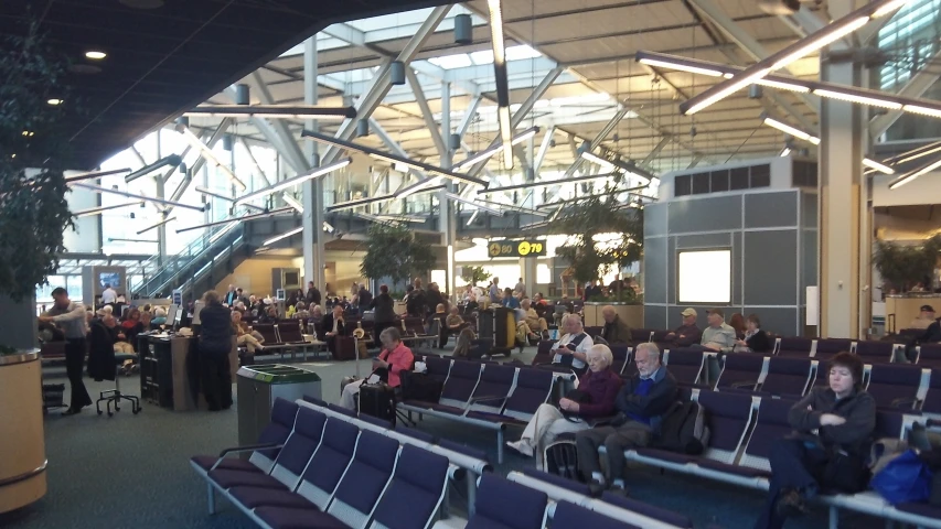 people sitting in seats in an airport terminal