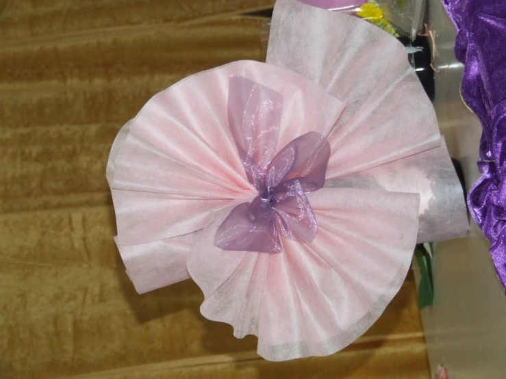 a close up image of a flower on a pink object