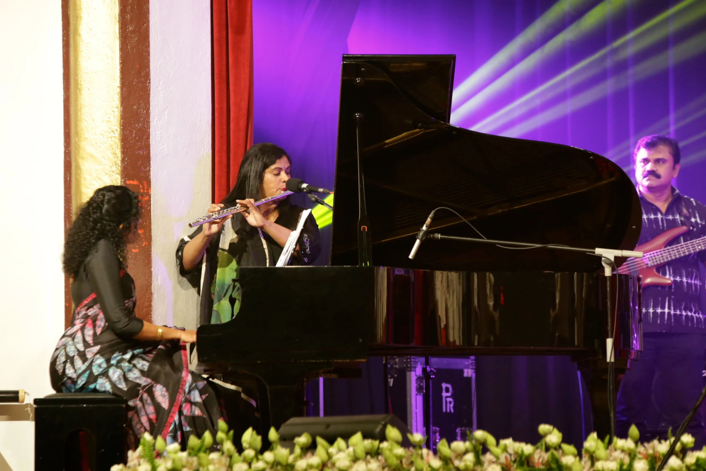 two women playing music on a stage