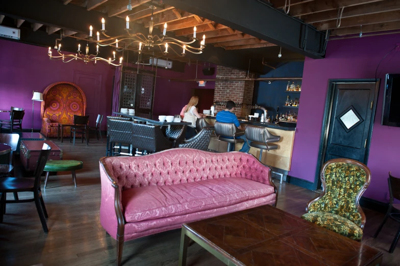 the interior of a very fancy restaurant with a red couch