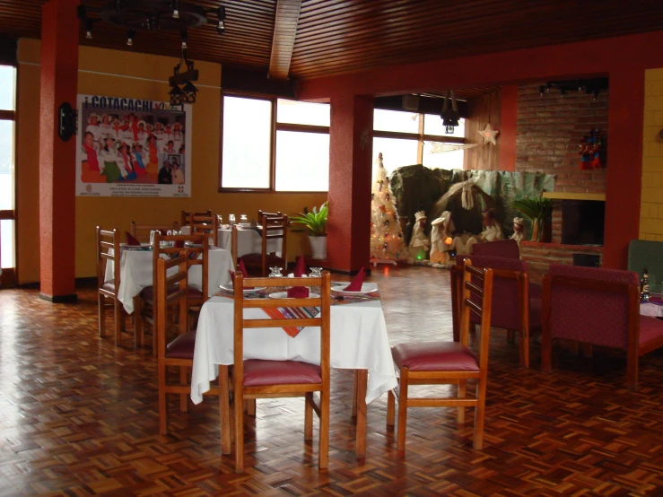 the inside of a restaurant with many tables and chairs