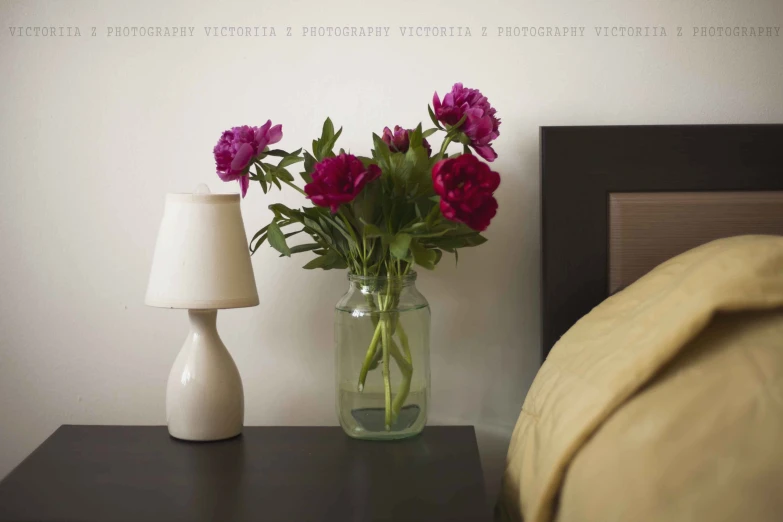 two vases with red flowers and white vase with pink flowers in them