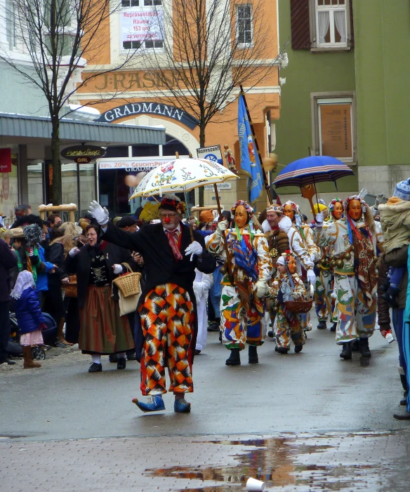 a group of people in costumes and holding umbrellas