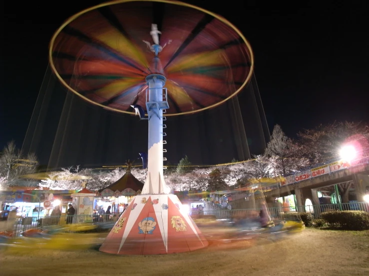 a colorful spinning disc with trees in the background