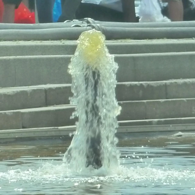 a fountain that is pouring water into the street