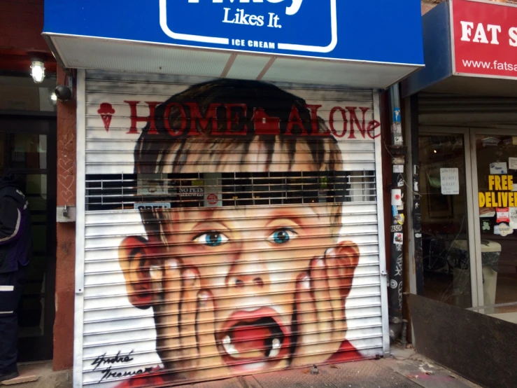 a closed up pizza shop with a mural of a child's face painted on the window