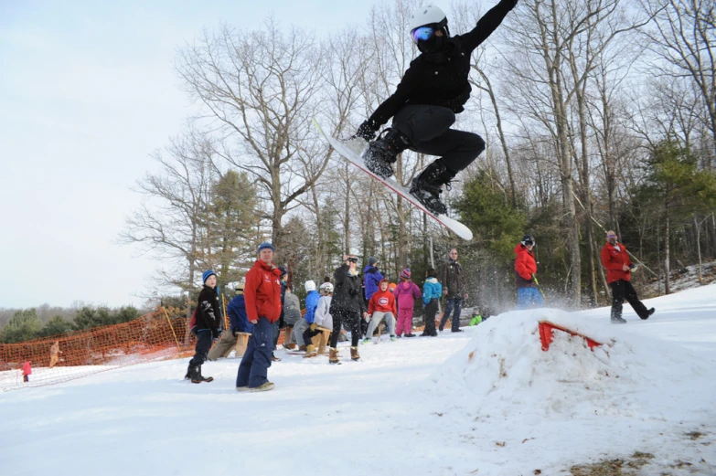 skier with black pants does an air trick