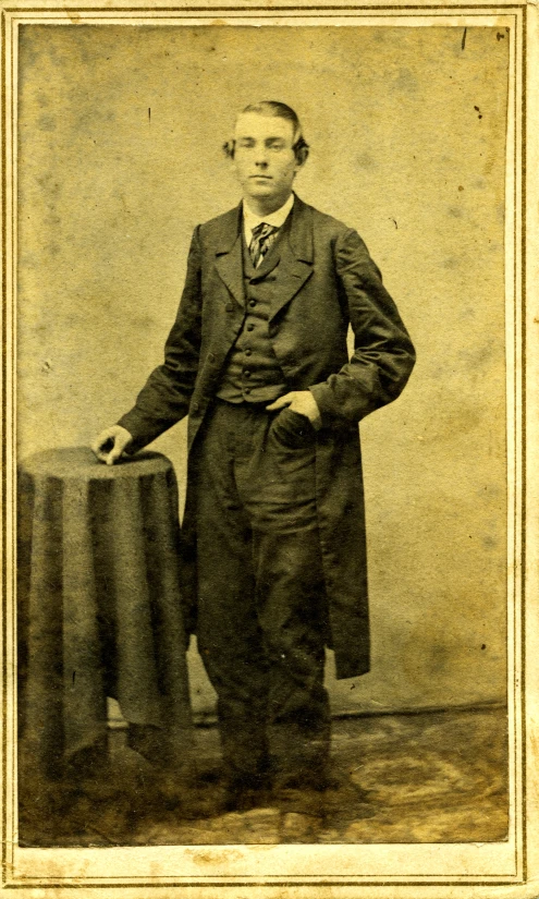 an old fashioned man wearing a suit and tie