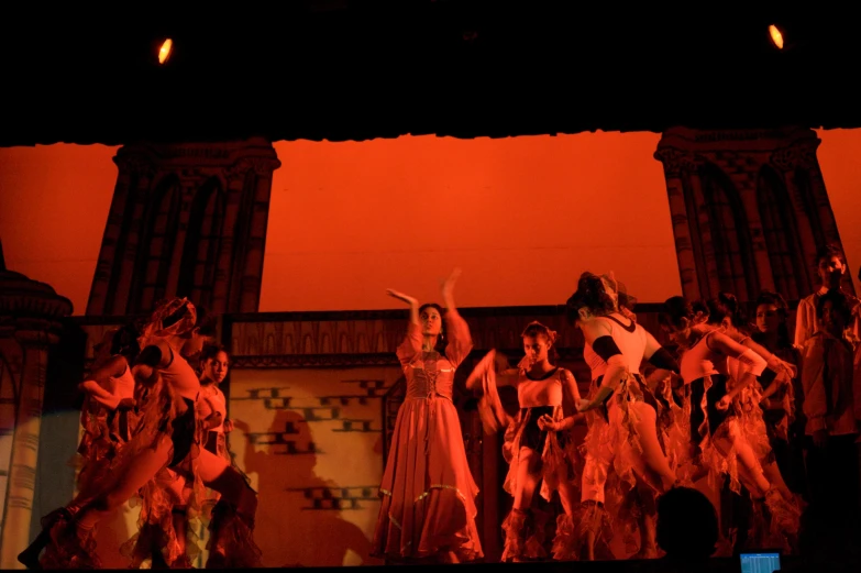 a group of young people perform a dance on stage