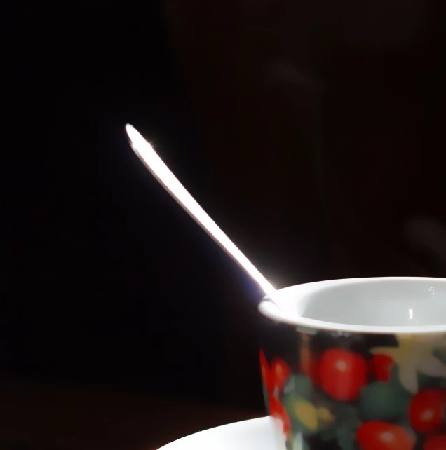 a small bowl with a spoon in it sitting on a table