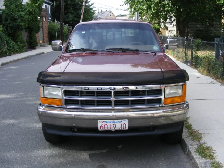 a red truck parked on the side of a city street