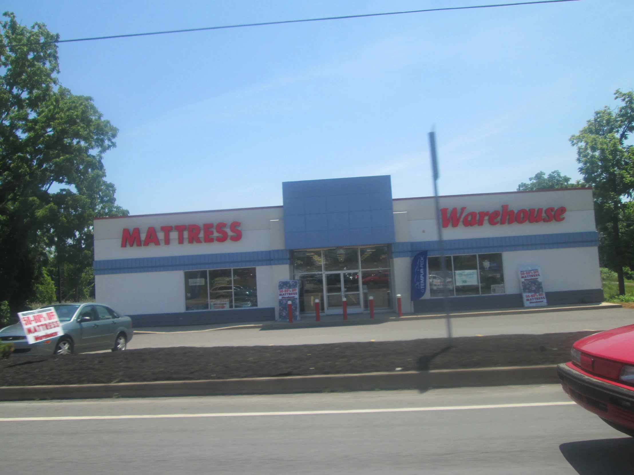 an image of a car parked in front of a warehouse