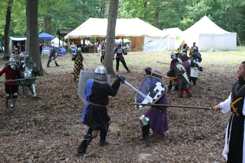 some knights with swords standing outside in the woods