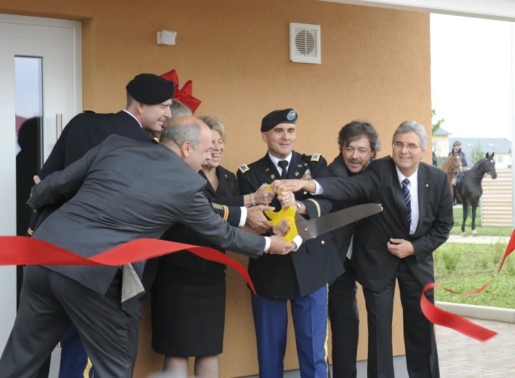 a group of men in suits  a ribbon outside