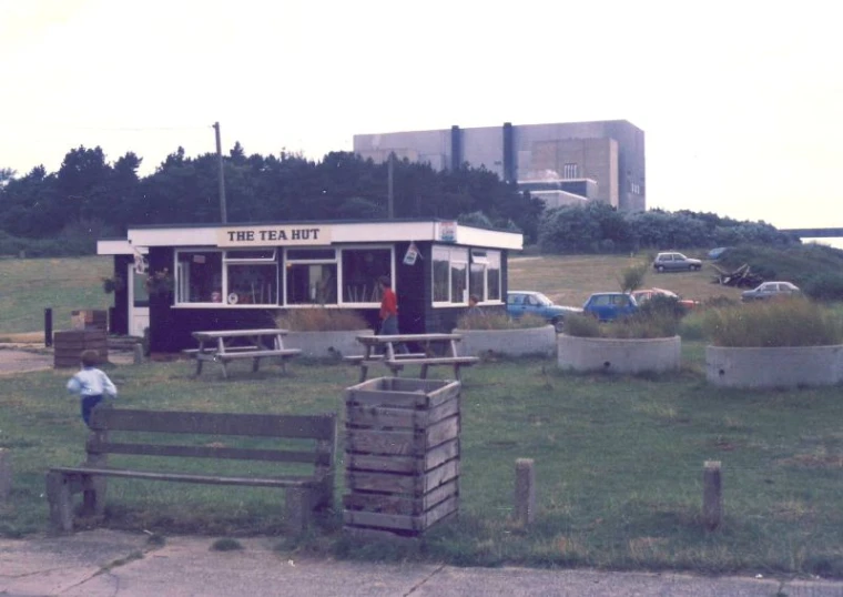 an old bank building near the beach with junk on it