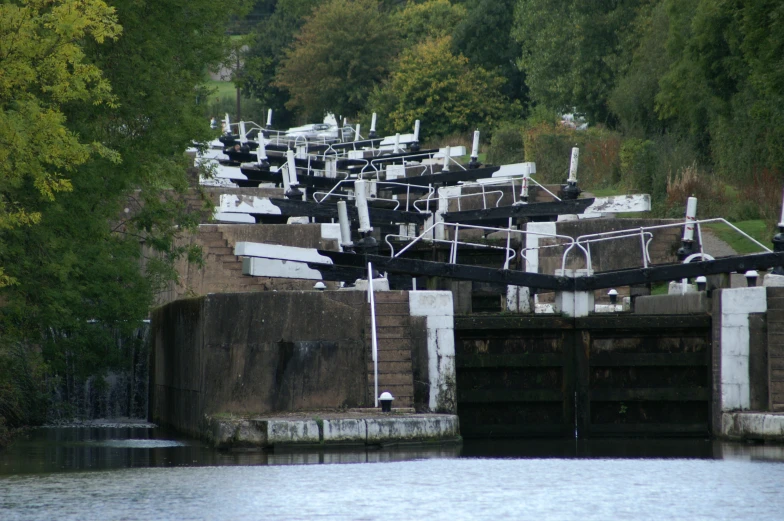 an old concrete dock covered in black and white boats