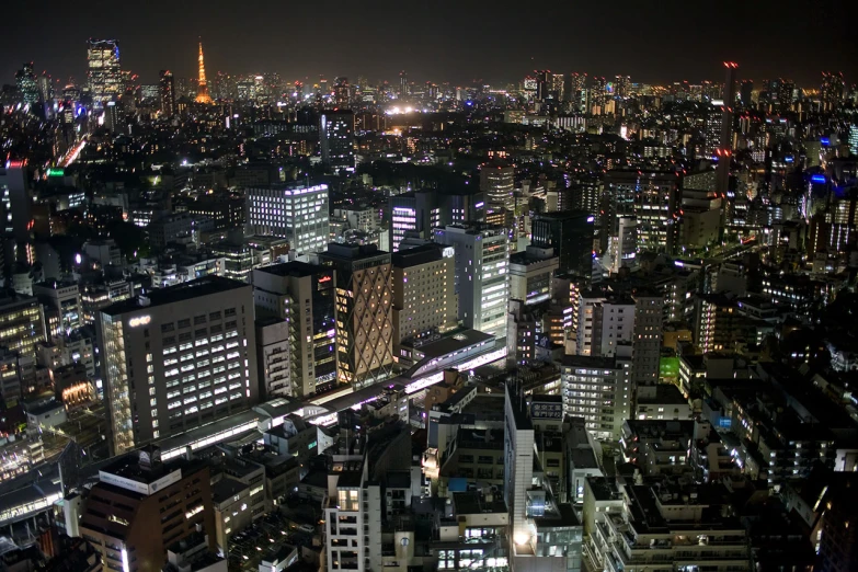 a dark and crowded cityscape at night with lights lit