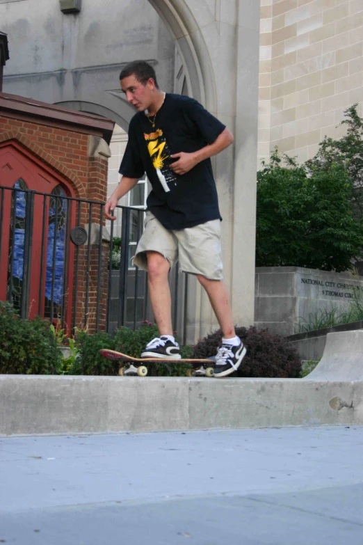 the guy is doing skateboarding tricks on the sidewalk