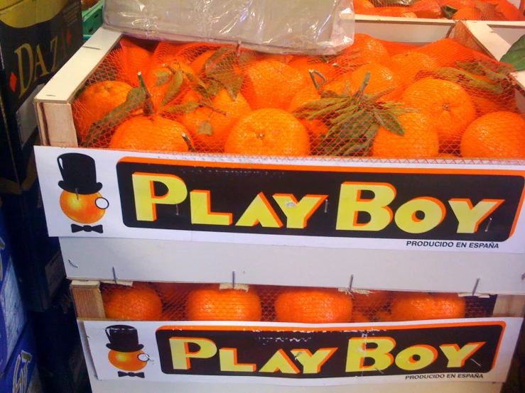 a large pile of oranges at a store display