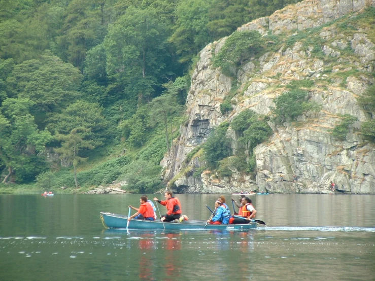 a group of people in small boats in the water