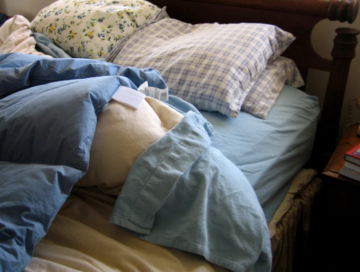 an image of blue comforters and sheets on bed