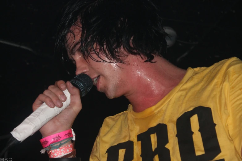 a man in a yellow shirt with a microphone