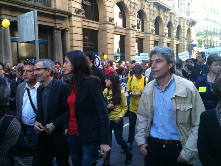 a large group of people are standing in front of a building