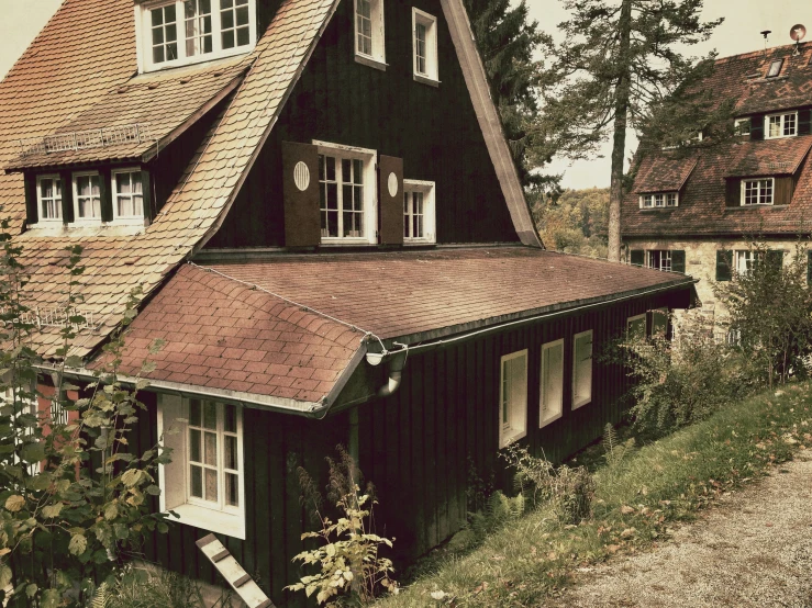 a house with many windows next to a hill