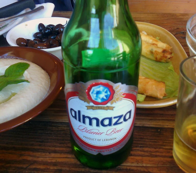 a bottle and a bowl with some food on it