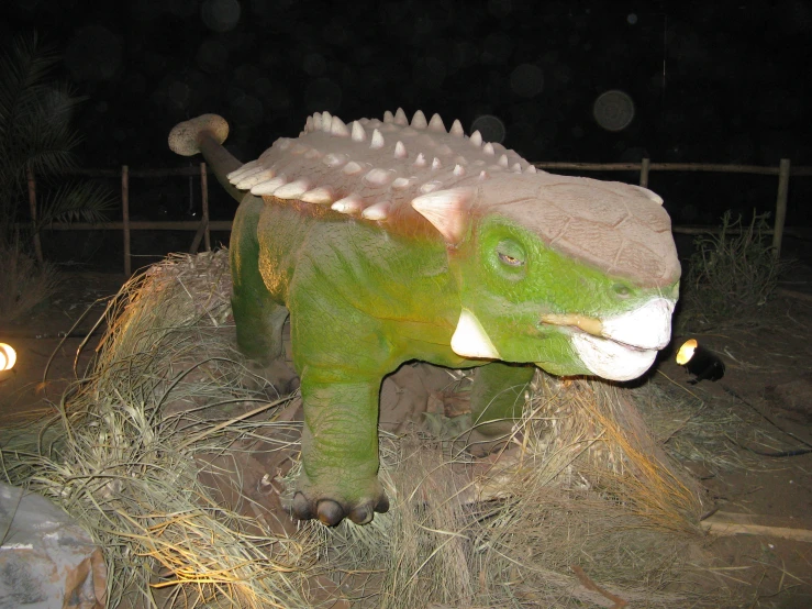 a fake dinosaur on display in the wild