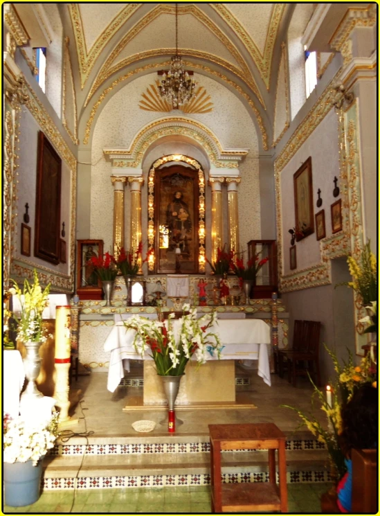 a church filled with flowers and pictures hanging on the walls