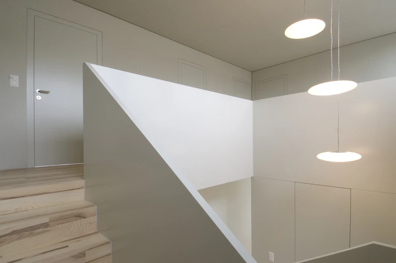 white room with stairs and lighting