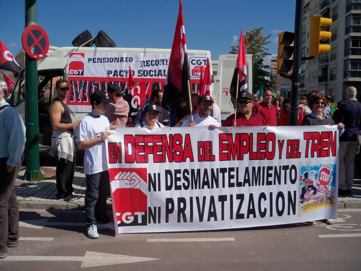 a man standing on a city street holding a sign