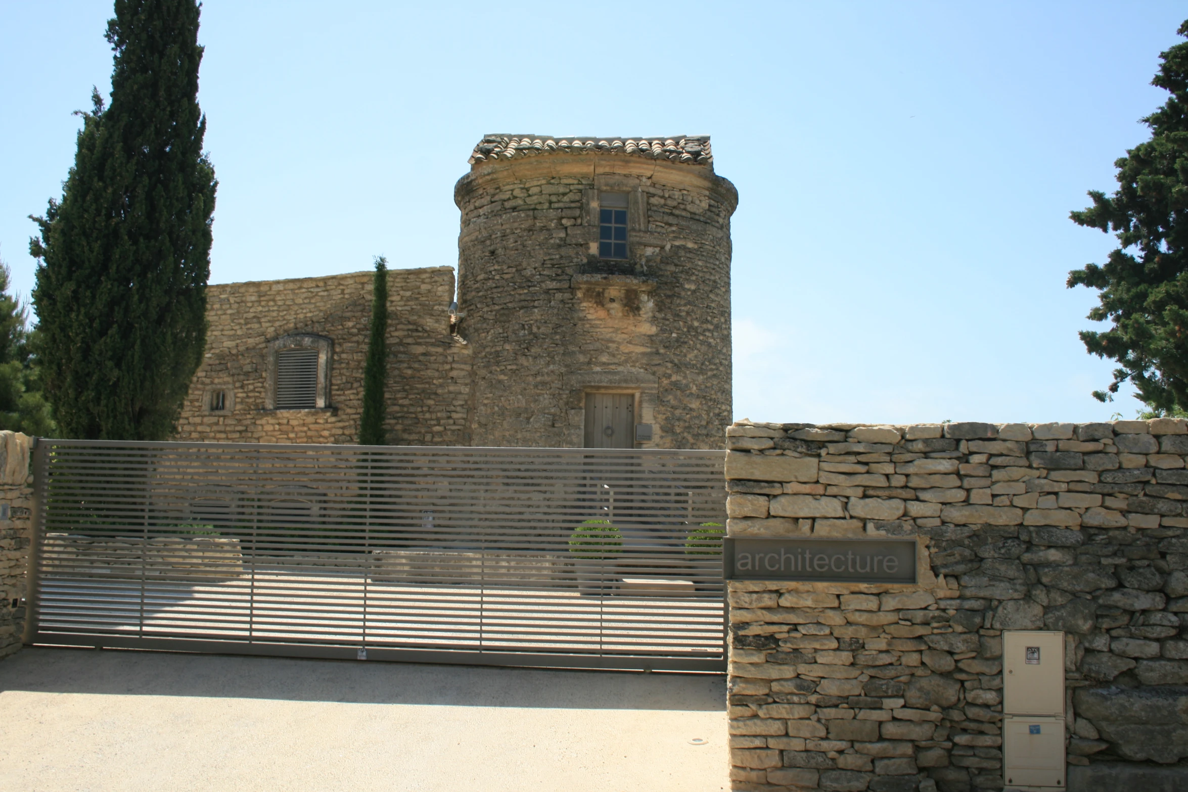 there is a stone castle with a fence in front