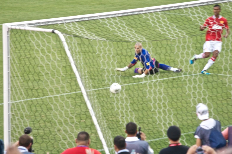 a goalie dives to save the ball