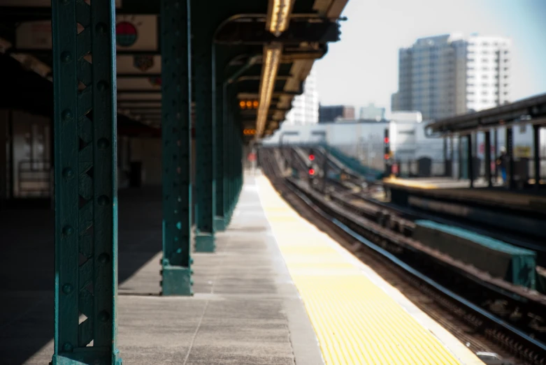 the tracks of an empty station are painted yellow