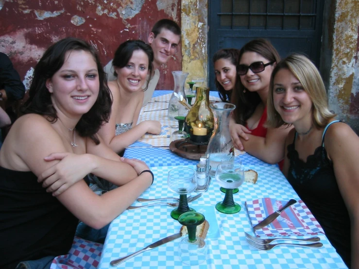 four women are sitting at a restaurant table