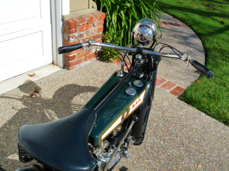 a close up of a motorcycle parked on the sidewalk