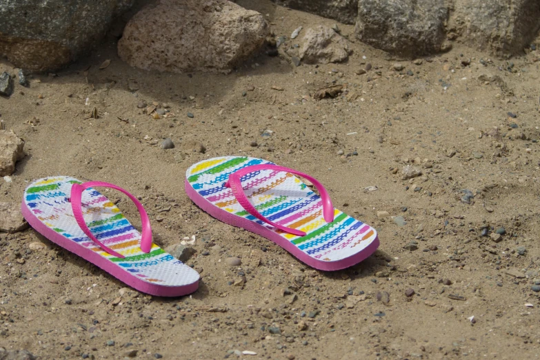 there is a pair of flip flops with bright colored soles