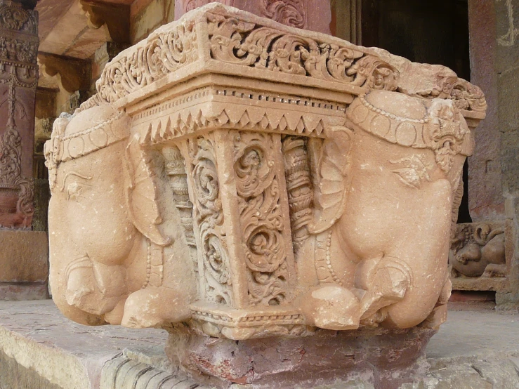 the stone base has intricate carvings around it